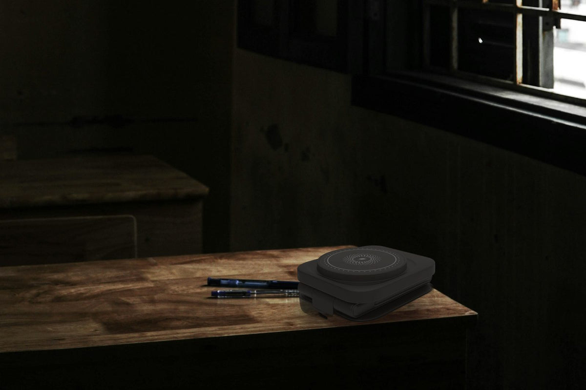 Black – folded, on a desk at night